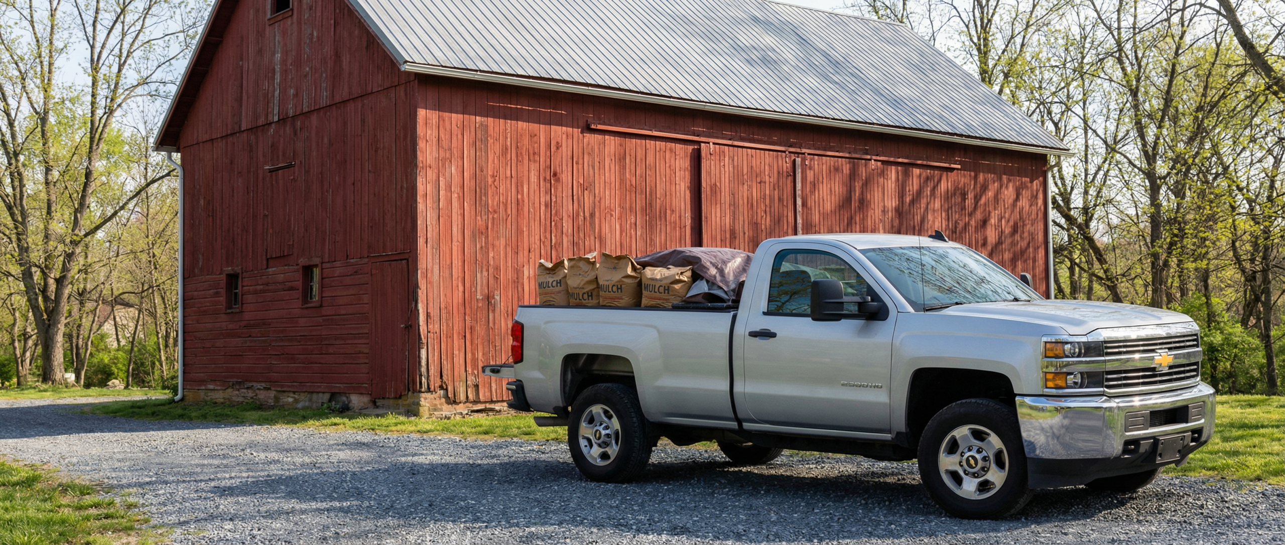 Used Chevrolet Silverado 2500HD hauling farm supplies in Manchester.