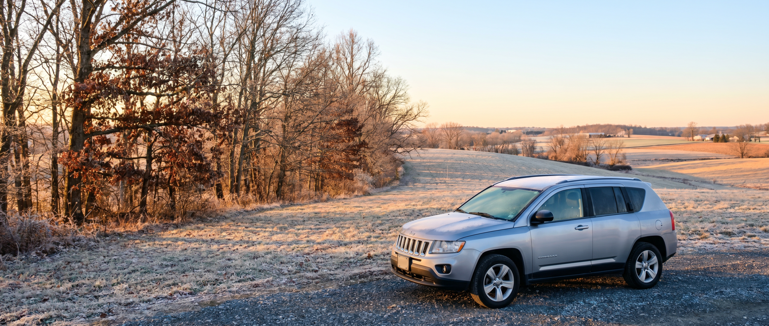 Pre-owned Jeep Compass 4x4 driving through winter weather in Hampstead.