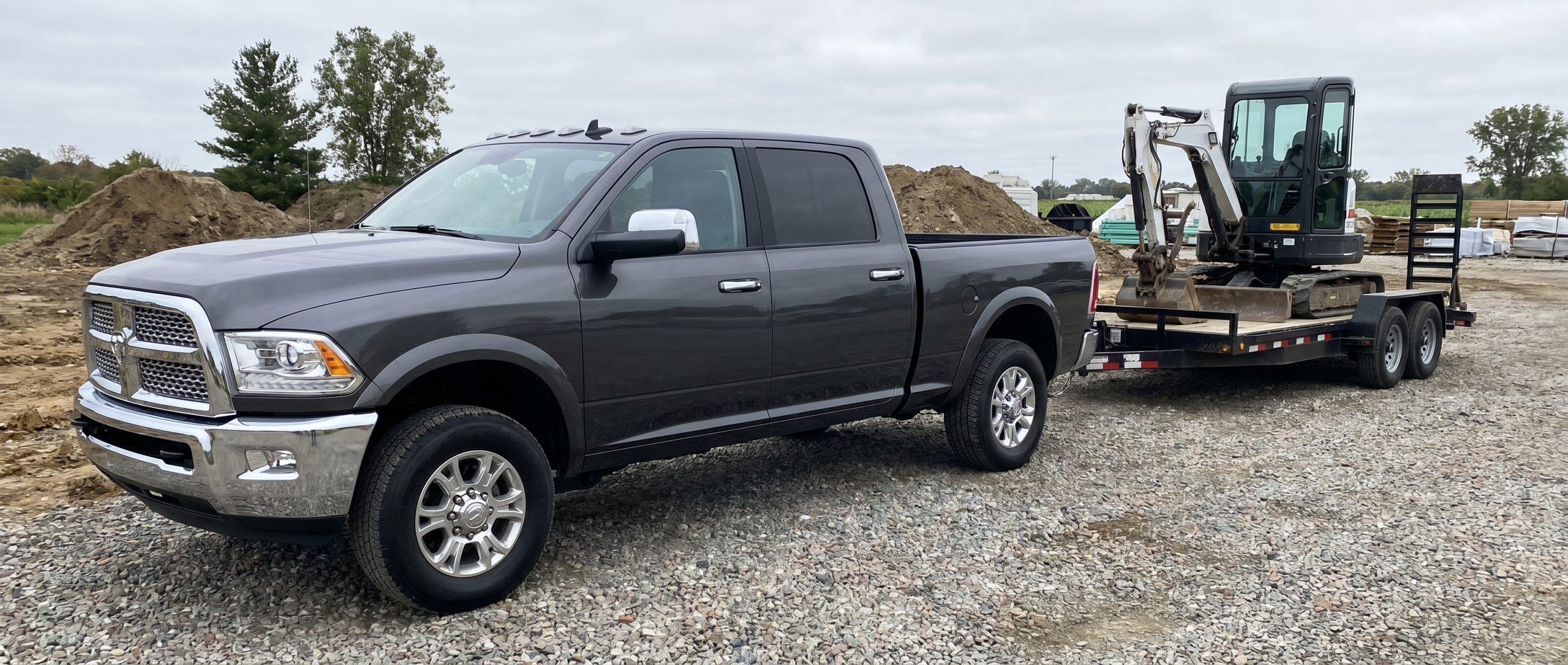 Pre-owned Ram 2500 with integrated trailer brake controller hauling equipment in Taneytown.